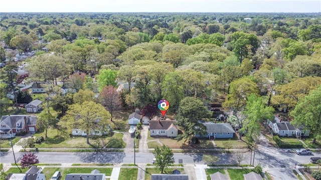 drone / aerial view featuring a residential view and a view of trees