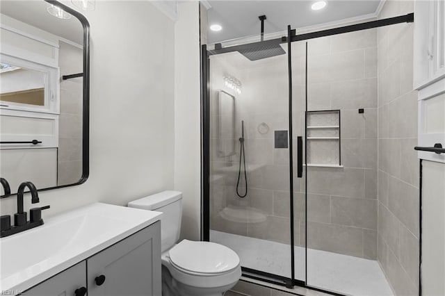 full bath featuring a shower stall, recessed lighting, vanity, and toilet