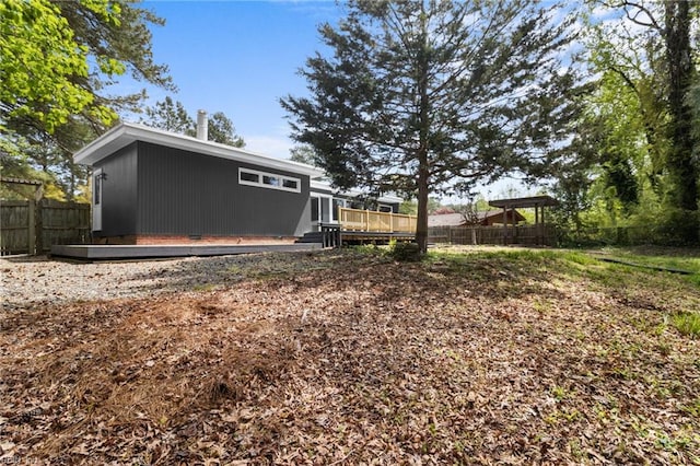 view of yard with a wooden deck and fence