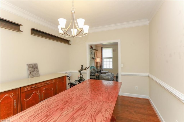 dining room with dark wood finished floors, baseboards, crown molding, and a chandelier