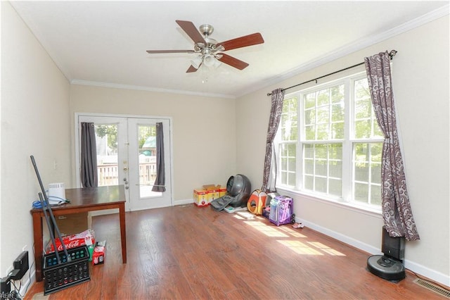 interior space featuring ornamental molding, a healthy amount of sunlight, french doors, and wood finished floors