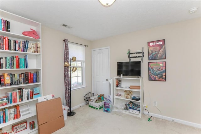 recreation room with carpet floors, visible vents, and baseboards