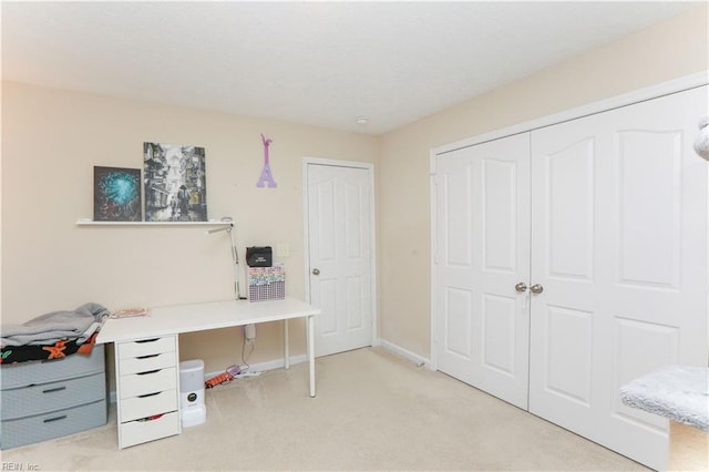carpeted home office with baseboards