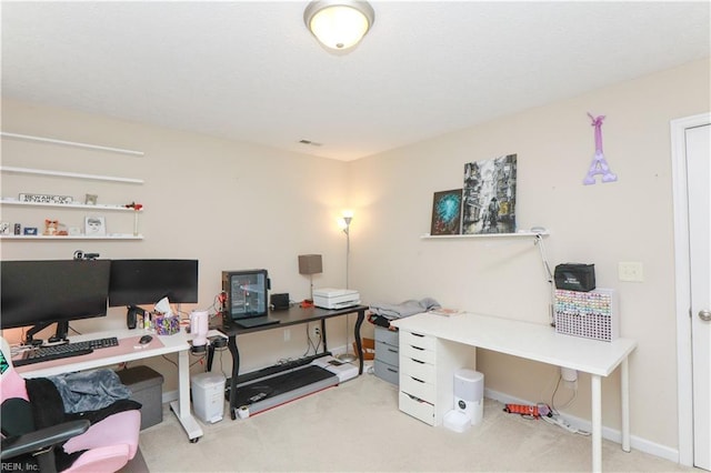 office area with visible vents, baseboards, and carpet flooring