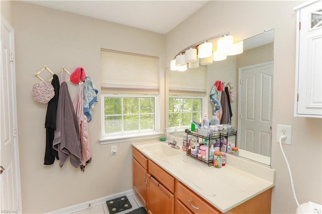 bathroom with baseboards, vanity, and tile patterned floors