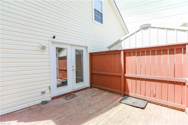 wooden terrace with fence and french doors