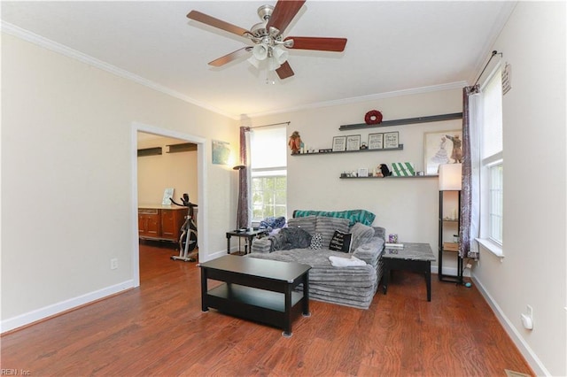 living room featuring baseboards, a ceiling fan, wood finished floors, and ornamental molding