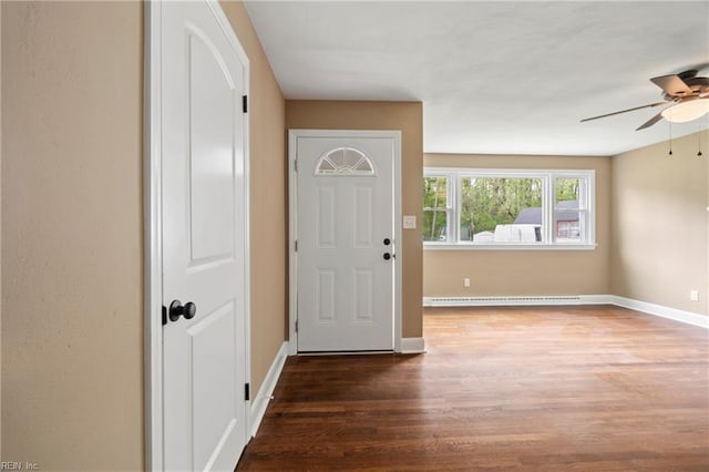 entrance foyer featuring baseboard heating, wood finished floors, ceiling fan, and baseboards