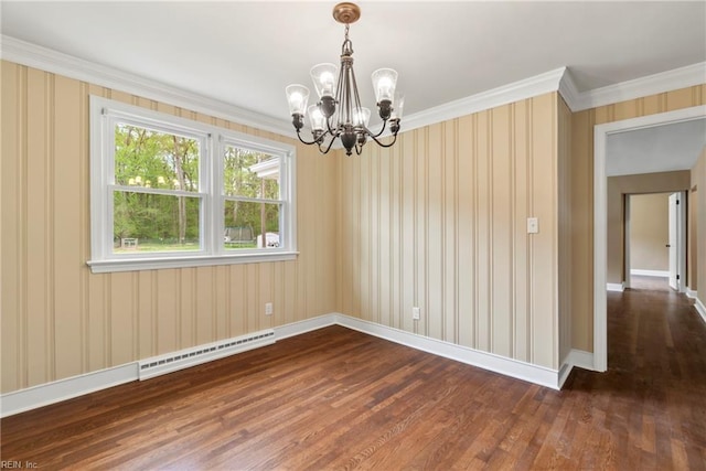 spare room featuring ornamental molding, baseboard heating, a chandelier, wood finished floors, and baseboards