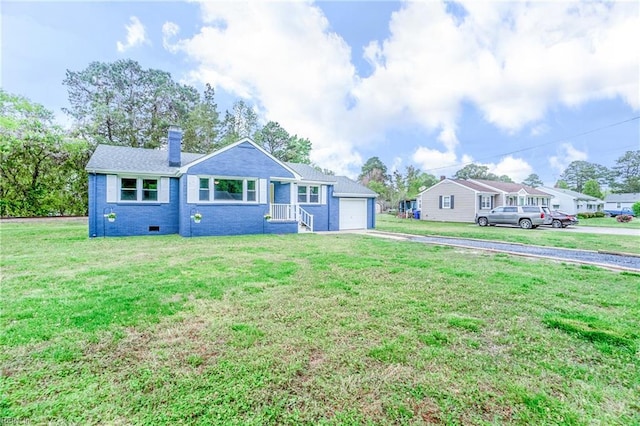 view of front of home featuring a front yard, a garage, driveway, and a chimney