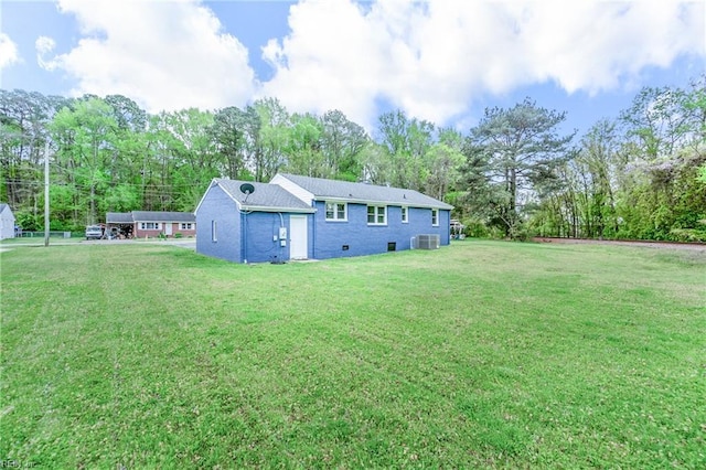 back of house with a yard and central AC unit