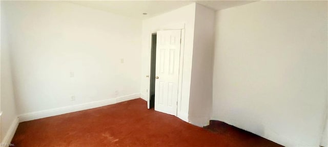 unfurnished room with carpet floors and baseboards