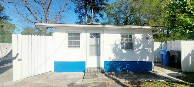 view of outbuilding featuring fence and an outdoor structure