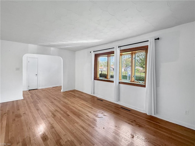 1279 Old Buckroe Rd, Hampton, VA 23663 - unfurnished room featuring arched walkways, light wood finished floors, baseboards, and visible vents