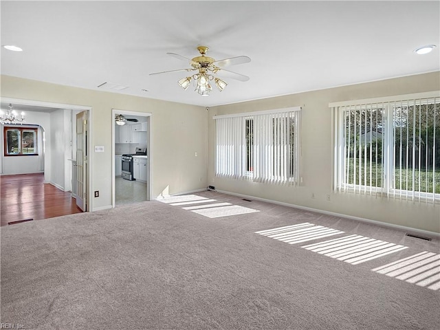1279 Old Buckroe Rd, Hampton, VA 23663 - spare room featuring visible vents, baseboards, carpet, and ceiling fan with notable chandelier