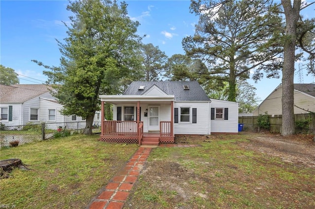 bungalow-style home with a fenced backyard, a front lawn, and a porch