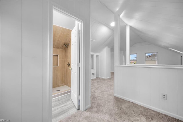 additional living space featuring carpet and lofted ceiling