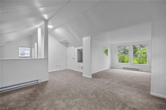 additional living space featuring carpet flooring, baseboard heating, and a healthy amount of sunlight