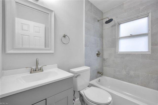 bathroom featuring toilet, vanity, and tub / shower combination