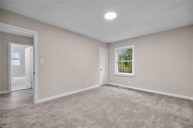 carpeted empty room with baseboards