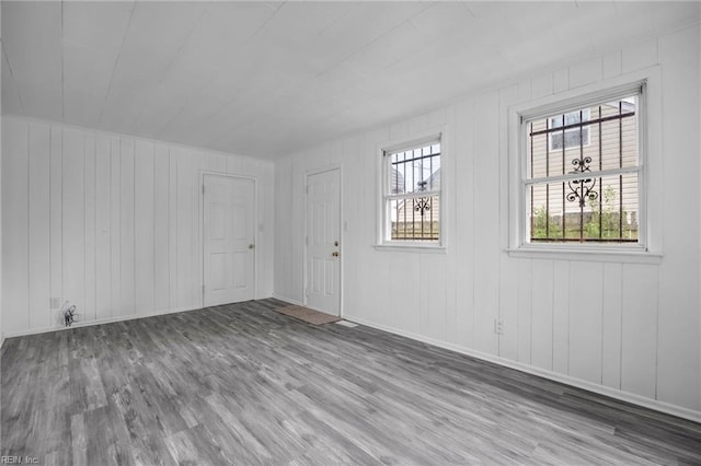 empty room featuring wood finished floors and baseboards