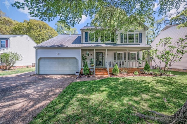943 Tabb Lakes Dr, Yorktown, VA 23693 - traditional home with driveway, a front lawn, an attached garage, and covered porch