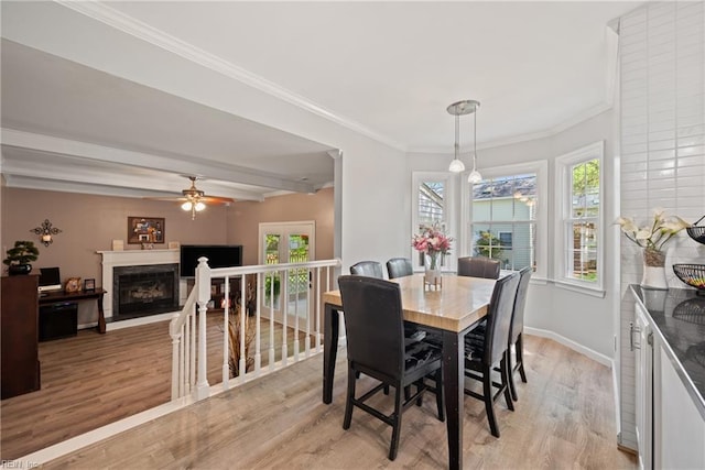 943 Tabb Lakes Dr, Yorktown, VA 23693 - dining area with ceiling fan, a fireplace, light wood-style flooring, baseboards, and beam ceiling
