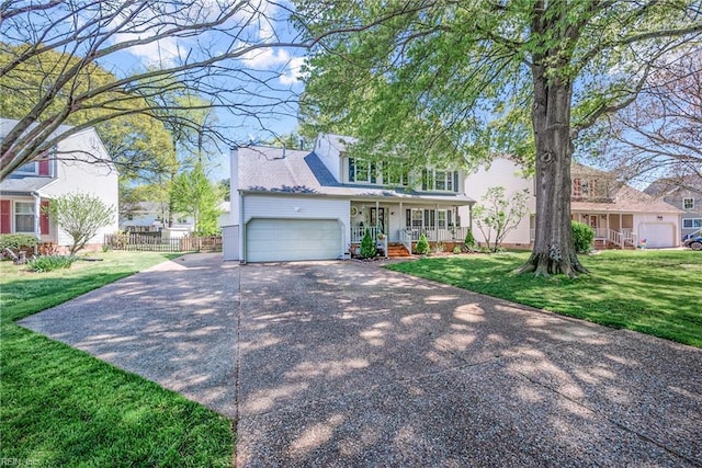 943 Tabb Lakes Dr, Yorktown, VA 23693 - traditional-style home with a garage, covered porch, a front yard, fence, and concrete driveway