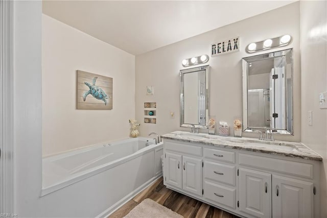 943 Tabb Lakes Dr, Yorktown, VA 23693 - full bath with a sink, double vanity, a shower stall, a garden tub, and wood finished floors