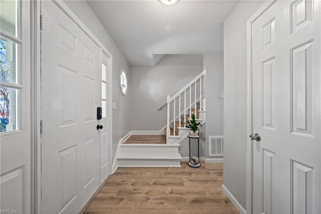 943 Tabb Lakes Dr, Yorktown, VA 23693 - entrance foyer with wood finished floors, baseboards, visible vents, and stairs