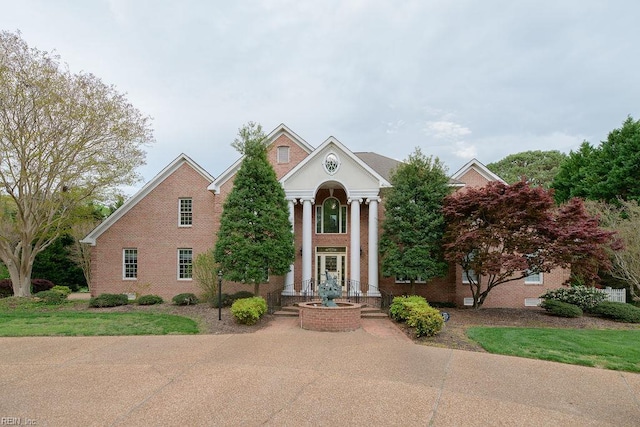 view of front of house featuring brick siding and french doors