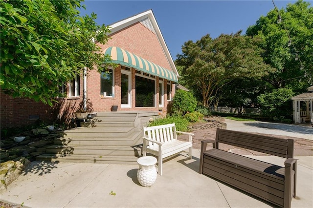 315 Wormley Creek Dr, Yorktown, VA 23692 - view of home's exterior with brick siding, a patio area, and an outdoor living space