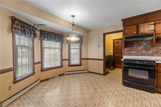 kitchen featuring visible vents, under cabinet range hood, washing machine and clothes dryer, black electric range oven, and a baseboard radiator