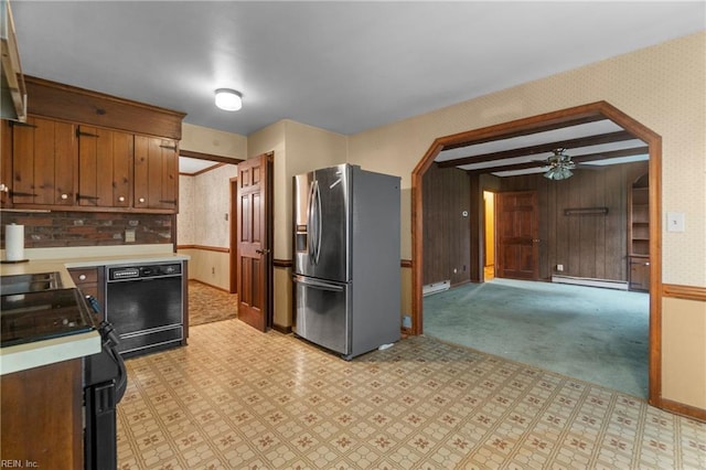 kitchen with wallpapered walls, baseboard heating, and black appliances