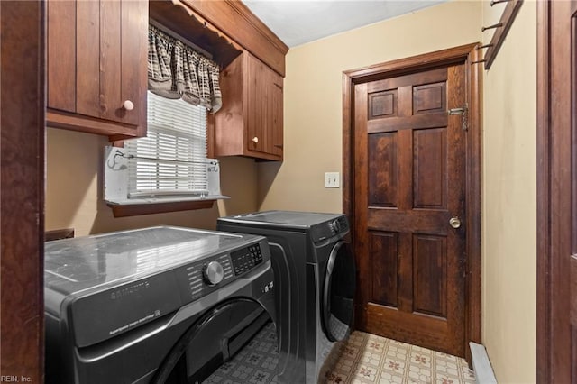 laundry area with cabinet space, washing machine and dryer, and light floors
