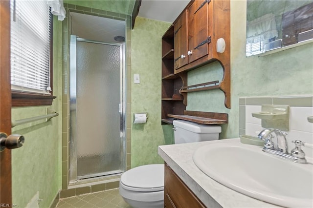 full bathroom with toilet, a stall shower, and vanity