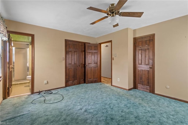 unfurnished bedroom featuring a closet, baseboards, carpet flooring, connected bathroom, and ceiling fan