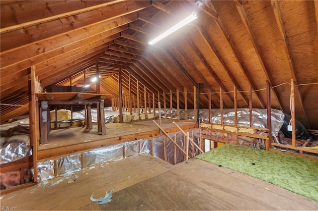 unfinished attic with an upstairs landing