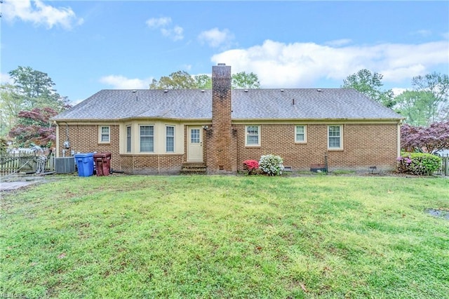 rear view of house featuring crawl space, central air condition unit, a lawn, and a chimney