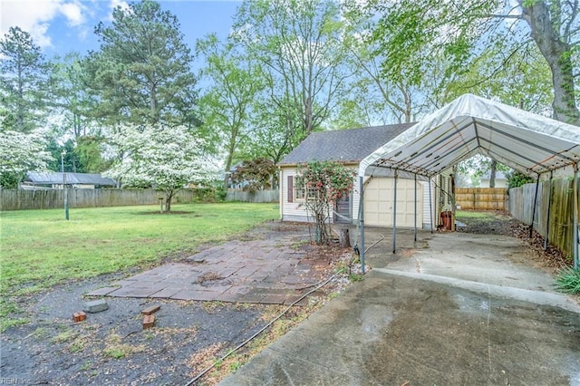 exterior space featuring a carport, driveway, a garage, and fence private yard