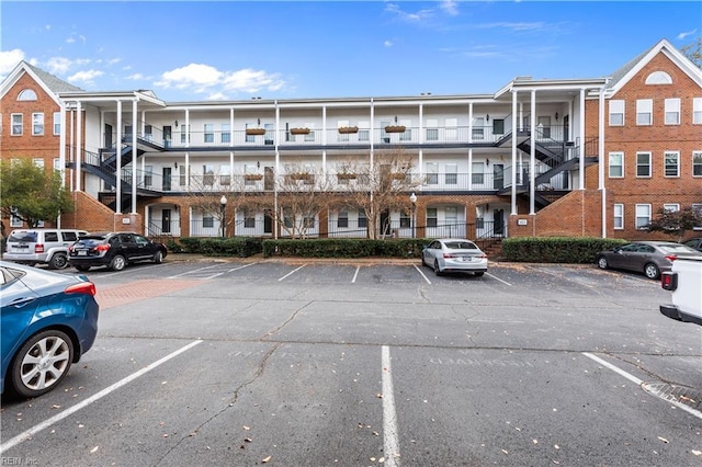view of building exterior with uncovered parking