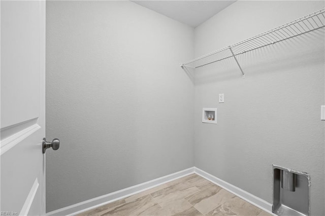 laundry room with baseboards, hookup for a washing machine, and laundry area