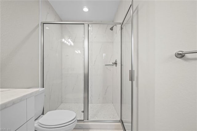 bathroom with a marble finish shower, toilet, recessed lighting, and vanity