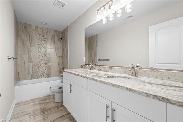full bathroom with visible vents, a sink, and toilet