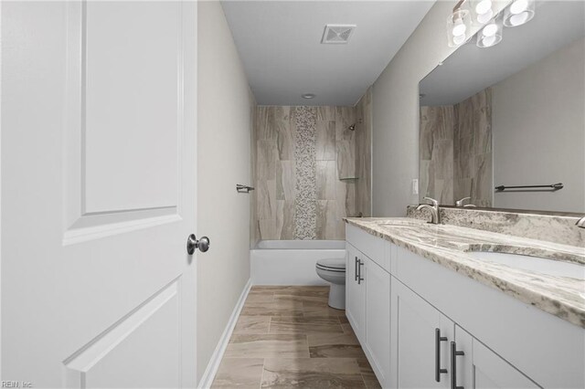 full bathroom with a sink, visible vents, toilet, and double vanity