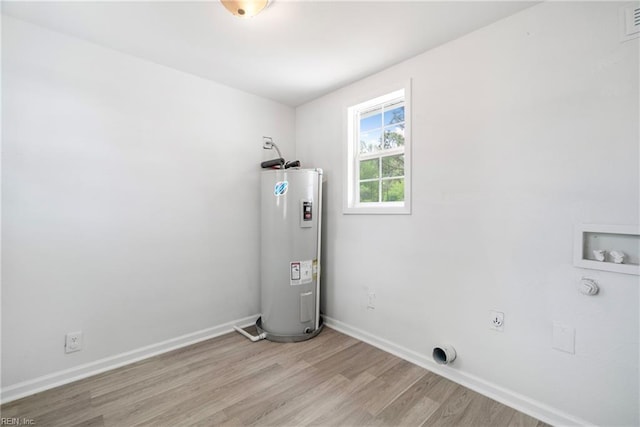 laundry room with laundry area, light wood-style flooring, water heater, hookup for an electric dryer, and washer hookup