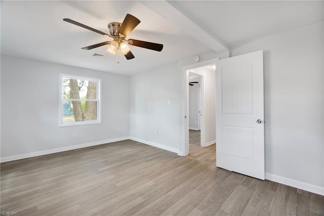 unfurnished room with visible vents, light wood-type flooring, baseboards, and a ceiling fan