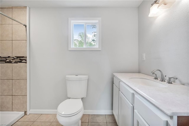 full bathroom featuring toilet, tiled shower, and tile patterned flooring