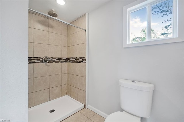 full bathroom featuring a shower stall, tile patterned floors, and toilet