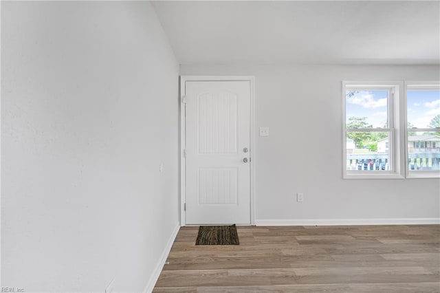 interior space featuring baseboards and wood finished floors